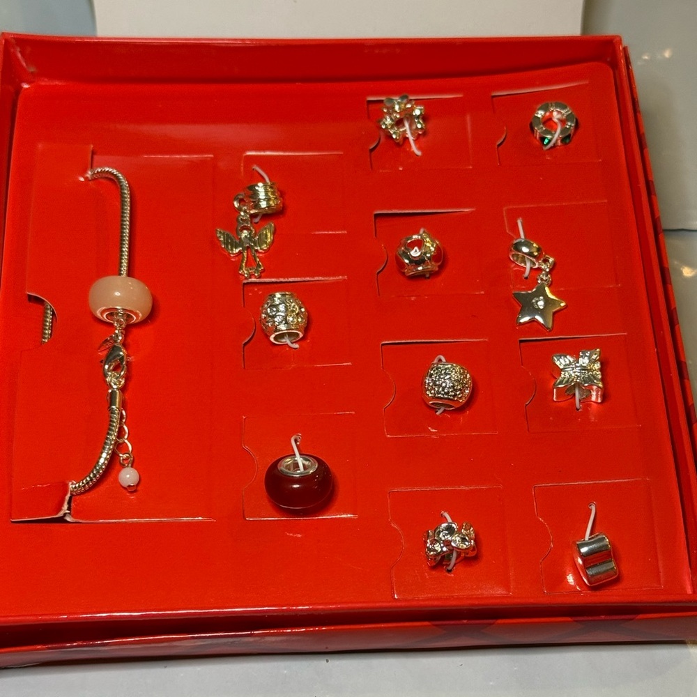 Avon cherished memories bracelet set. Silver tone. New in box. 12 charms